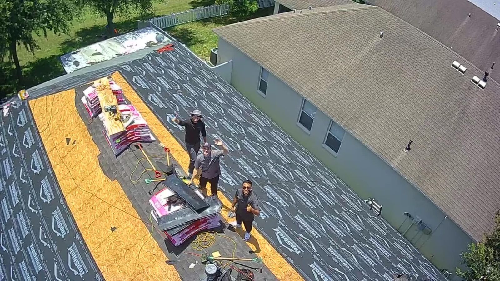 RoofSource crew re-decking a commercial roof, aerial view