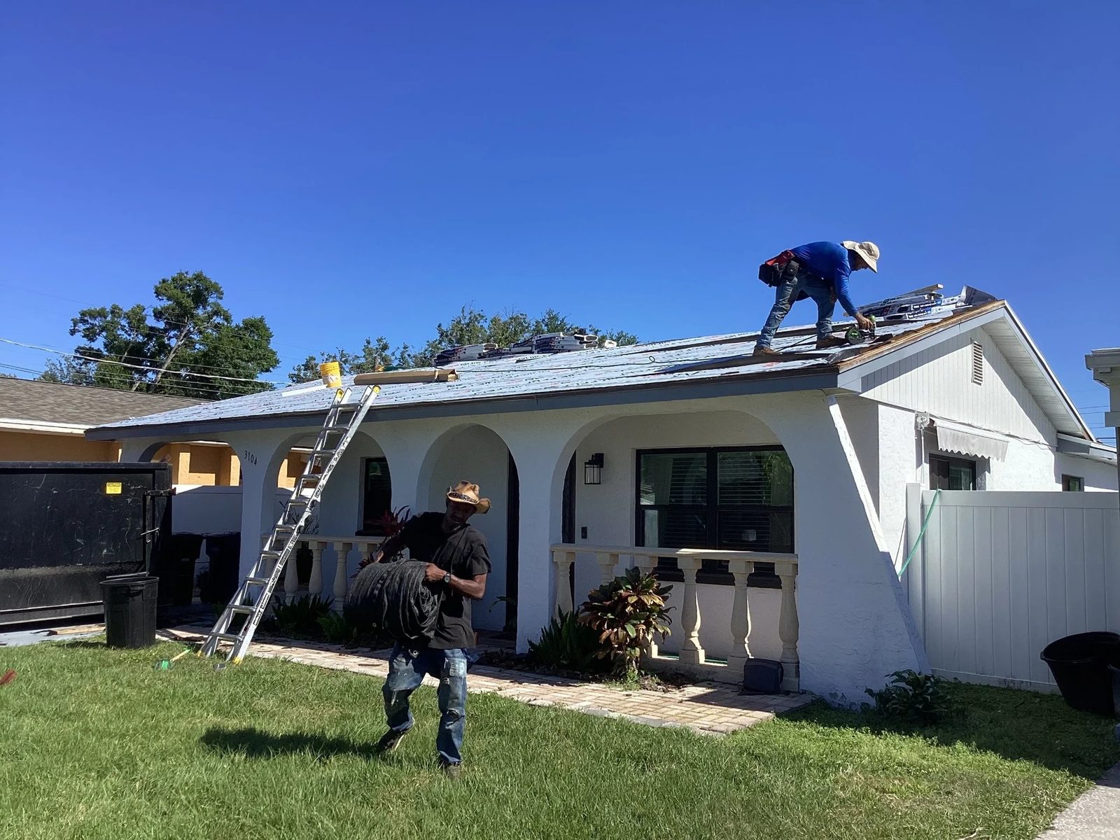 Roof repair crew working on a shingle roof