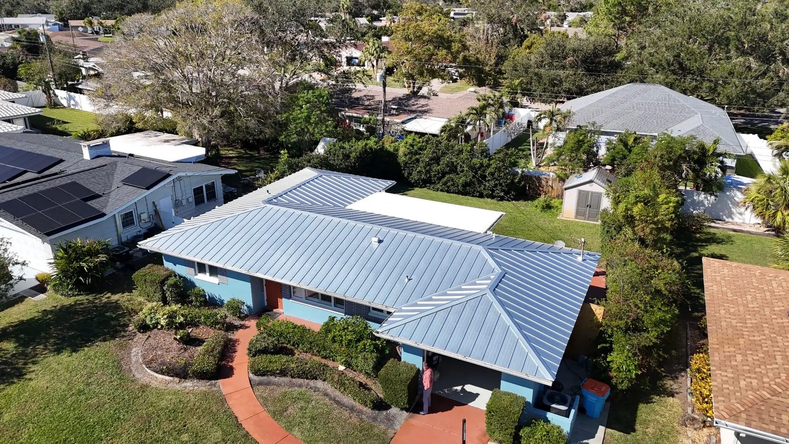 Completed standing seam metal roof, blue panel finish